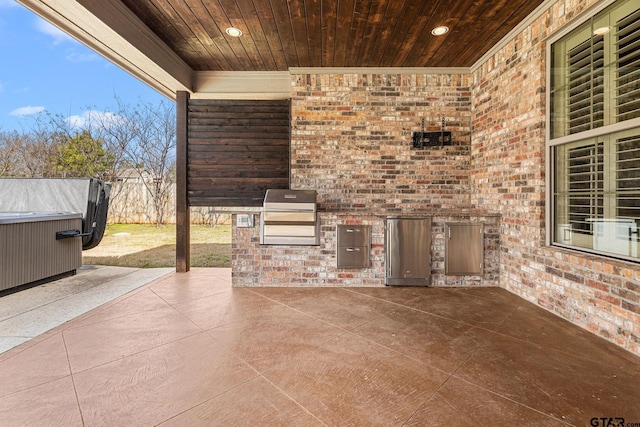 view of patio featuring area for grilling, fence, and a grill