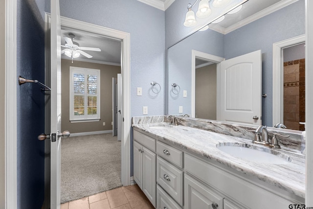 full bathroom with a ceiling fan, crown molding, double vanity, and a sink