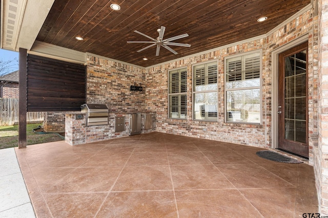 view of patio / terrace featuring grilling area, a ceiling fan, fence, and an outdoor kitchen