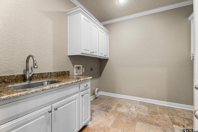 clothes washing area with ornamental molding, hookup for a washing machine, a textured wall, hookup for an electric dryer, and a sink