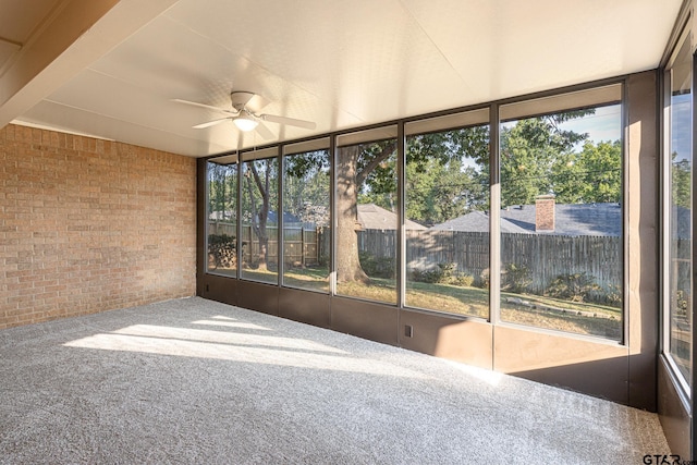 unfurnished sunroom with ceiling fan