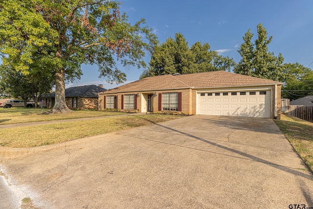 single story home with a front yard and a garage