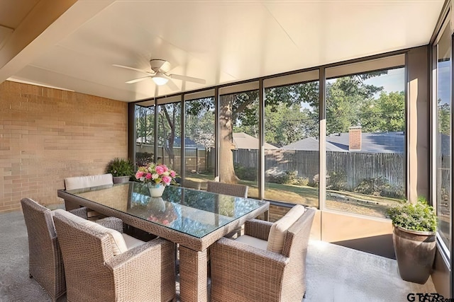 sunroom / solarium featuring ceiling fan