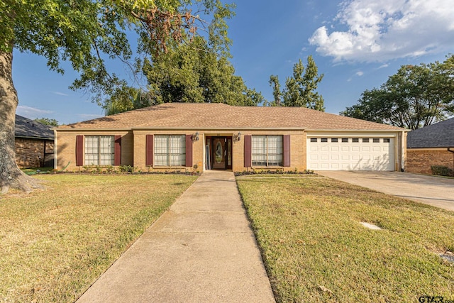 single story home with a garage and a front lawn