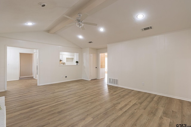 spare room with light wood-type flooring, lofted ceiling with beams, and ceiling fan