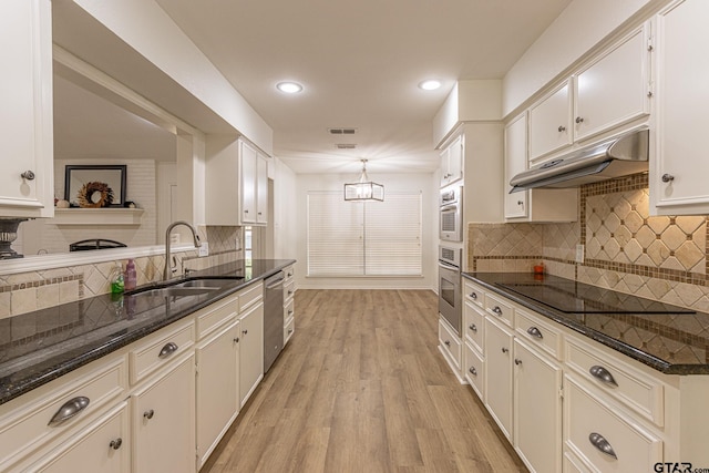 kitchen with stainless steel appliances, sink, light hardwood / wood-style floors, white cabinetry, and hanging light fixtures