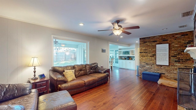 living room featuring ceiling fan and dark wood-type flooring