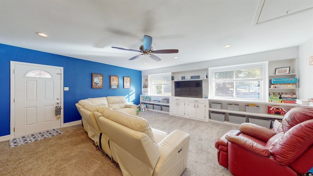 carpeted living room featuring ceiling fan