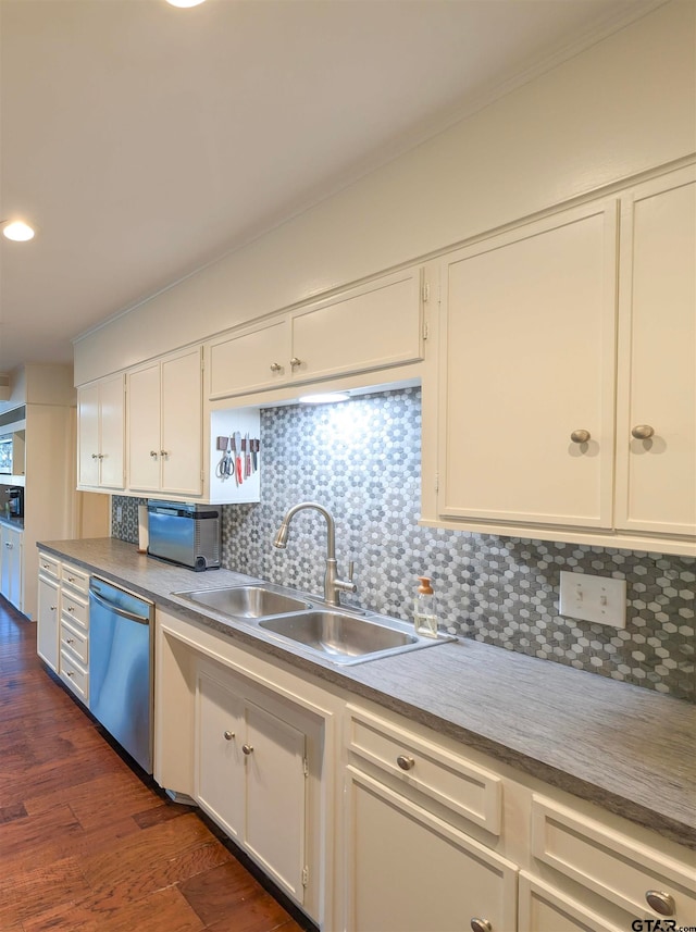 kitchen featuring white cabinets, sink, stainless steel dishwasher, tasteful backsplash, and dark hardwood / wood-style flooring