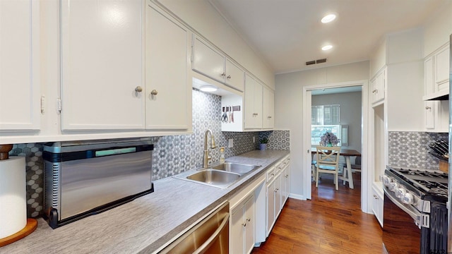 kitchen with white cabinets, appliances with stainless steel finishes, dark hardwood / wood-style flooring, and sink