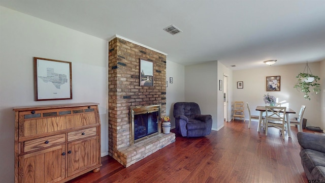 living room featuring a fireplace and dark hardwood / wood-style flooring