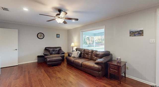 living room with ceiling fan, dark hardwood / wood-style flooring, and ornamental molding