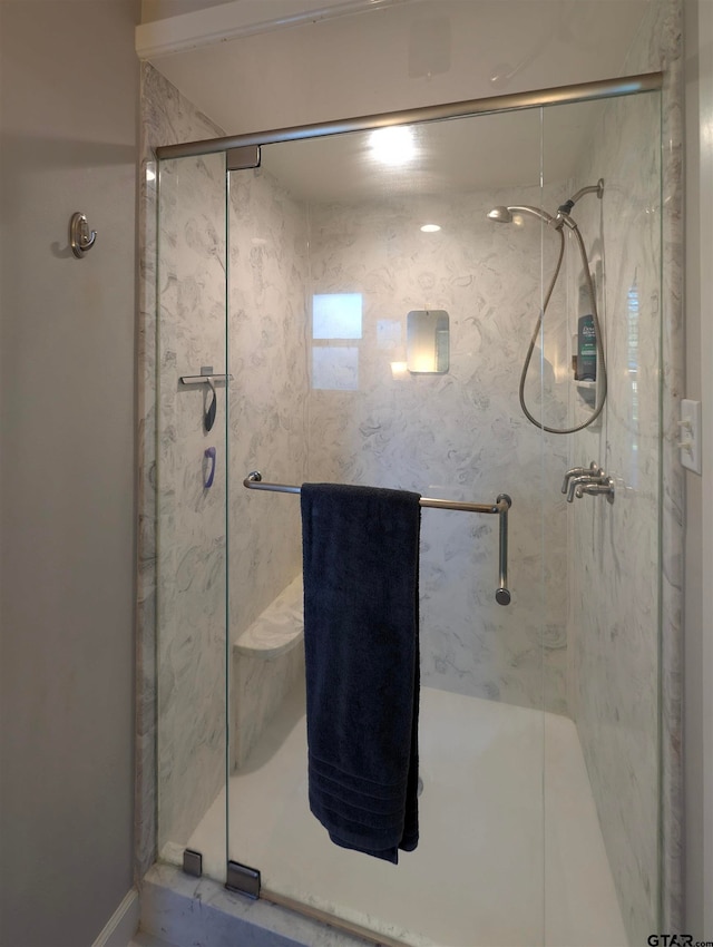 bathroom with a shower with shower door