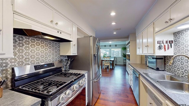 kitchen featuring white cabinets, sink, stainless steel appliances, and dark wood-type flooring