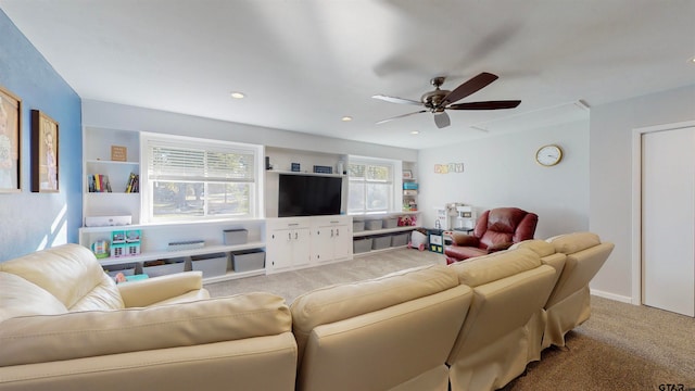 carpeted living room featuring ceiling fan