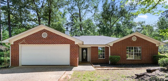 ranch-style home with a garage, driveway, a chimney, and brick siding