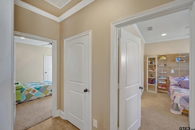 hall with light colored carpet and ornamental molding