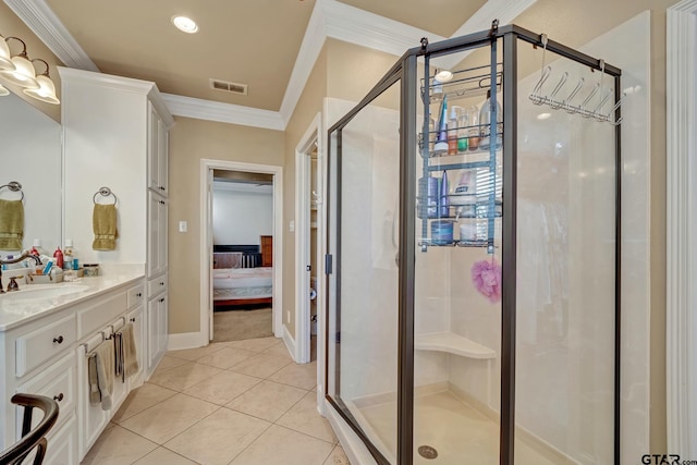 bathroom featuring a shower with door, vanity, tile patterned flooring, and ornamental molding