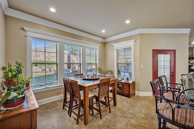 tiled dining room featuring a healthy amount of sunlight and crown molding