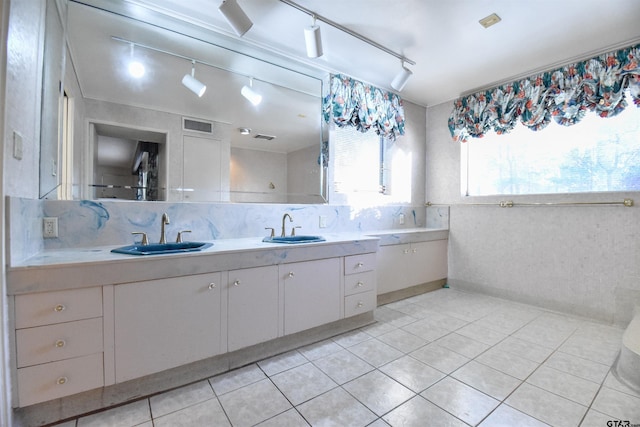 bathroom with vanity, tile patterned flooring, and decorative backsplash