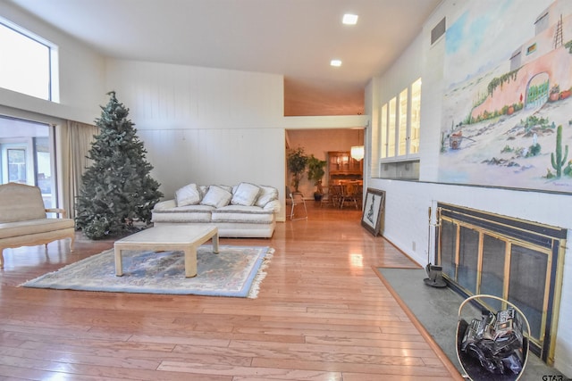 living room featuring a high ceiling and light wood-type flooring