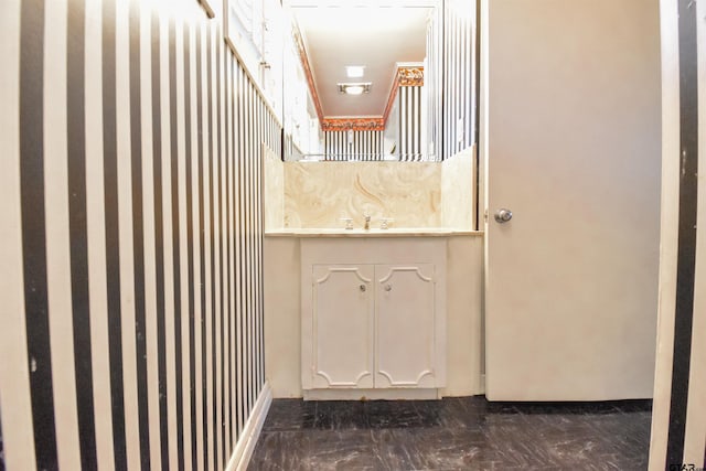 bathroom featuring crown molding and vanity