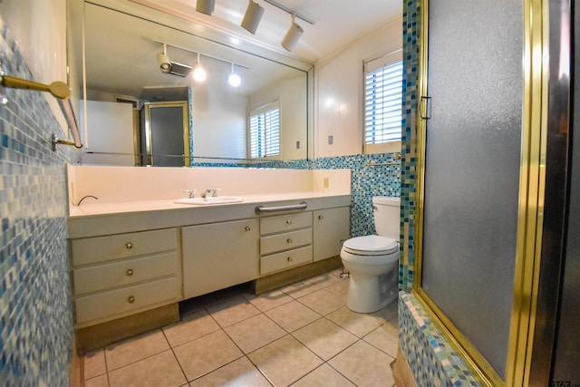 bathroom with toilet, tasteful backsplash, tile patterned floors, an enclosed shower, and vanity