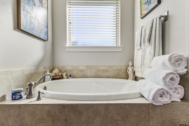 bathroom with a relaxing tiled tub