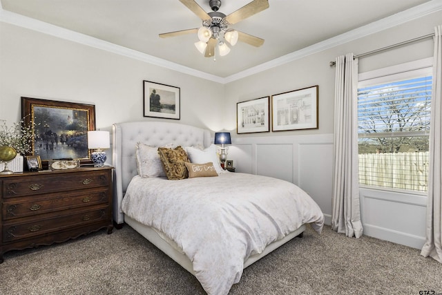 carpeted bedroom with ceiling fan and crown molding