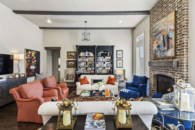 living room featuring beam ceiling, wood-type flooring, and a brick fireplace