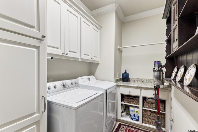 washroom with cabinets, ornamental molding, and independent washer and dryer