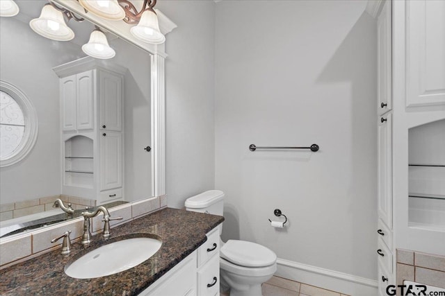 bathroom with vanity, tile patterned flooring, and toilet