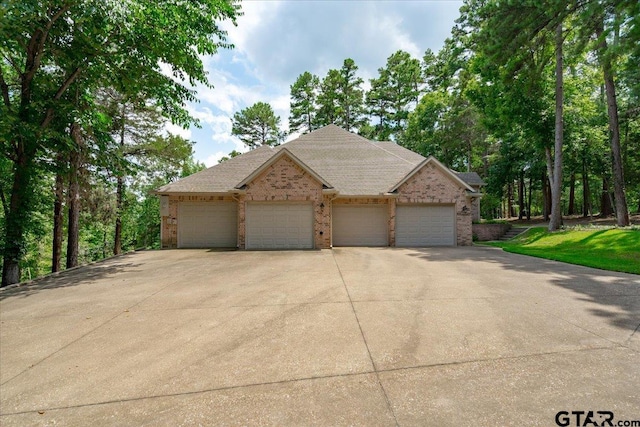 view of front of property featuring a garage and a front lawn