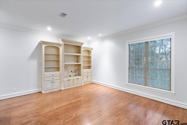 unfurnished living room with light wood-type flooring and ornamental molding