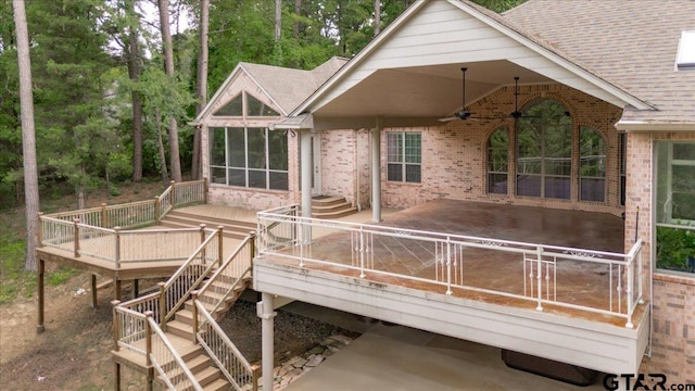 rear view of property featuring ceiling fan and a deck