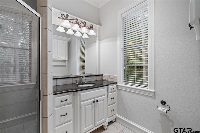 bathroom featuring tile patterned flooring, vanity, and a shower with door