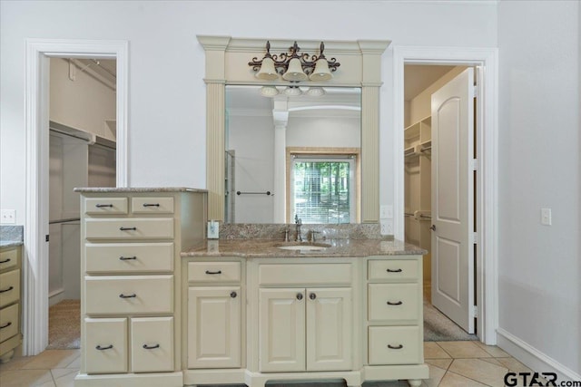 bathroom featuring vanity, tile patterned floors, and ornamental molding