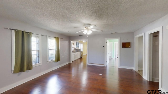 280 Dickard St, Hawkins, TX 75765 - unfurnished living room with visible vents, baseboards, ceiling fan, wood finished floors, and a textured ceiling