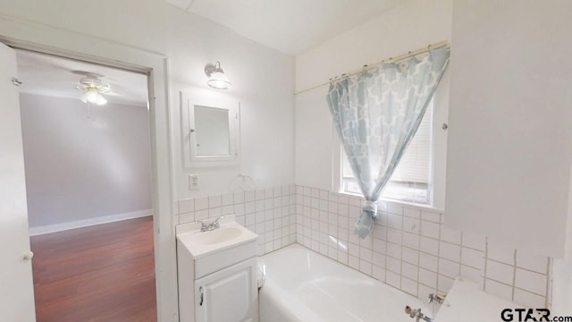 280 Dickard St, Hawkins, TX 75765 - full bath with a garden tub, wood finished floors, baseboards, ceiling fan, and vanity