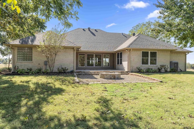1036 High Meadow Dr, Mount Vernon, TX 75457 - back of property featuring a fire pit, brick siding, a yard, a shingled roof, and a patio