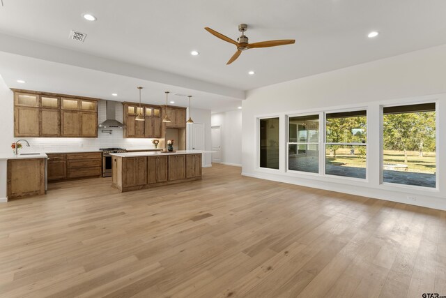 1036 High Meadow Dr, Mount Vernon, TX 75457 - unfurnished living room featuring light wood-type flooring, recessed lighting, ceiling fan, a sink, and baseboards