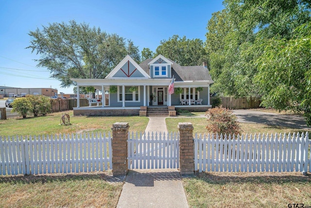 view of front of house with a porch and a front yard