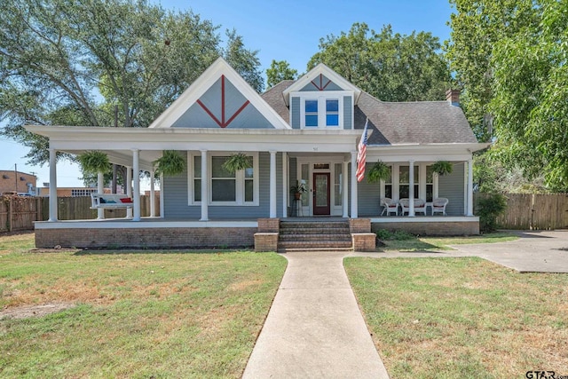 view of front of home with covered porch and a front yard