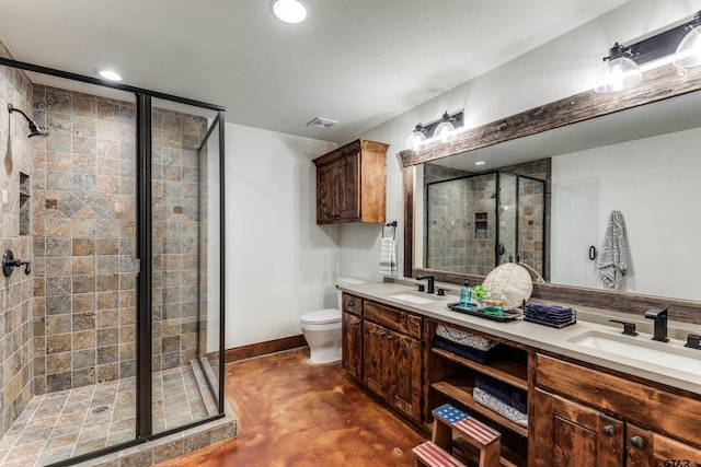 bathroom featuring double vanity, a stall shower, concrete floors, and a sink