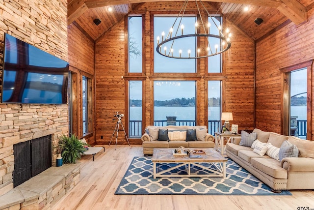 unfurnished living room with a chandelier, beam ceiling, wood ceiling, and wood finished floors