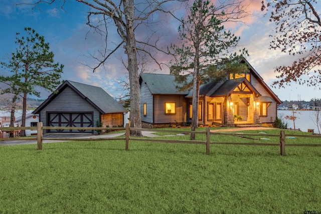 chalet / cabin with a front yard and a garage