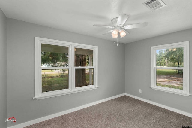 carpeted empty room featuring ceiling fan