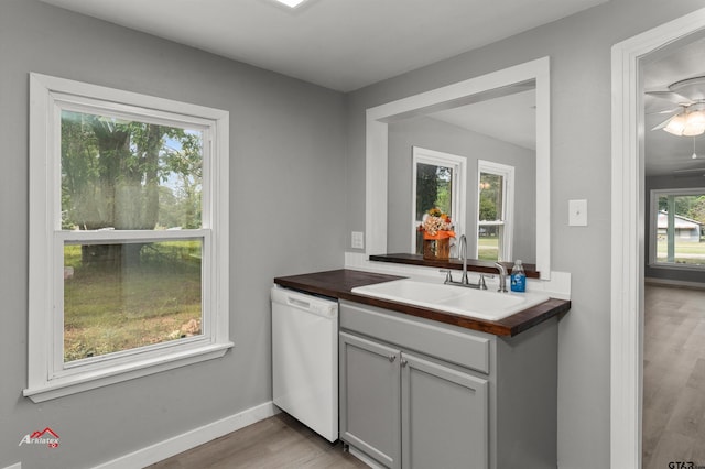 kitchen featuring dishwasher, light hardwood / wood-style flooring, sink, and ceiling fan