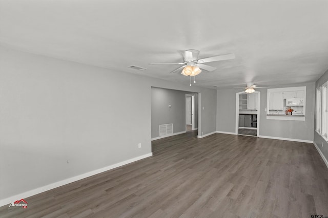 unfurnished living room with ceiling fan and dark hardwood / wood-style flooring