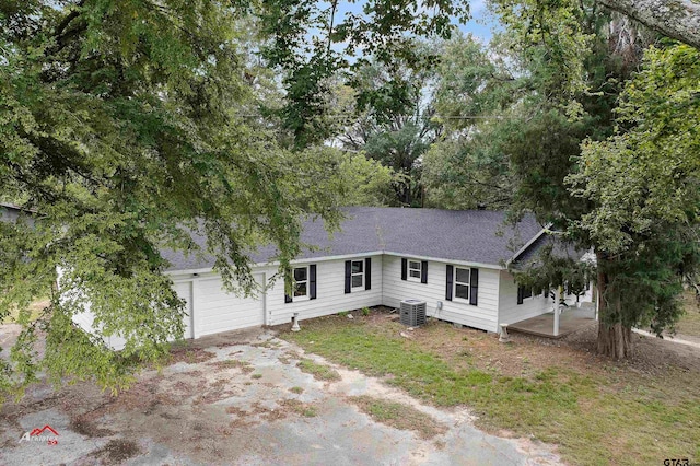 view of front of house featuring central air condition unit and a garage